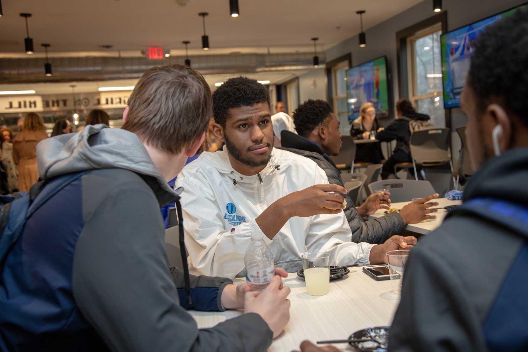 Students sitting at table talking